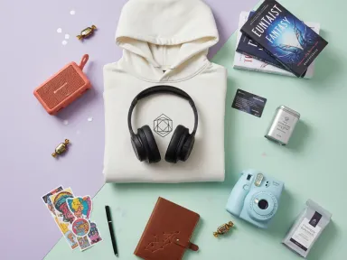 A collection of thoughtful birthday gift options for teenagers arranged on a pastel background